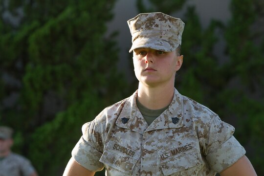 Sgt. Lindsey Schindler, commander of troops and crew master with Marine Aerial Refueling and Transportation Squadron (VMGR) 352, stands at parade rest during an evening colors ceremony aboard Marine Corps Air Station Miramar, Calif., June 10. The ceremony recognized the San Diego Chargers for their service to military members in surrounding communities. The event featured 3rd Marine Aircraft Wing and MCAS Miramar noncommissioned officers as part of the Committed and Engaged Leadership initiative, originated by Maj. Gen. Steven Busby, 3rd MAW commanding general.
