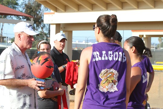 Maj. Gen. Steven Busby, 3rd Marine Aircraft Wing commanding general, presents the winning team the Committed and Engaged Spouses’ Sports League kickball trophy, aboard Marine Corps Air Station Miramar, Calif., June 14. . The Committed and Engaged Spouse initiative, started by Busby, highlights the service and sacrifice of military spouses, and works to develop opportunities to engage the community in camaraderie.