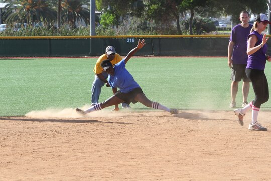Laranisha Cutolo, a military spouse and Gainesville, Fla., native, slides into second base during a kickball tournament, aboard Marine Corps Air Station Miramar, Calif., June 14. Cutolo played on the Huskies team, consisting of members of Marine Aircraft Group 16 Marines and spouses. The Committed and Engaged Spouses’ Sports League was developed as part of Commanding General Maj. Gen. Steven Busby’s Committed and Engaged Spouse initiative. The initiative highlights military spouses for their service and sacrifice, and works to develop opportunities for camaraderie.