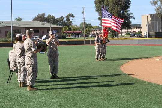 Members of the 3rd Marine Aircraft Wing Band and a color guard present the colors before the Committed and Engaged Spouses’ Sports League kickball tournament aboard Marine Corps Air Station Miramar, Calif., June 14. The Committed and Engaged Spouse initiative, started by Busby, highlights the service and sacrifice of military spouses, and works to develop opportunities to engage the community in camaraderie.