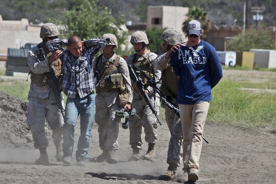 Marines with 7th Engineer Support Battalion, 1st Marine Logistics Group, detain two role players who were caught burying improvised explosive devices during a field training exercise aboard Camp Pendleton, Calif., June 12, 2014. The enemies were caught just outside of an area in which Marines were constructing a forward operating base, a secured and fortified location used to increase operational tempo in forward deployed areas. The FOB was approximately 40,000 sq. meters and consisted of four 20-foot tall guard posts, a command and control center, as well as several other structures used for facilitating the safe and effective environment for planning and conducting operations.


