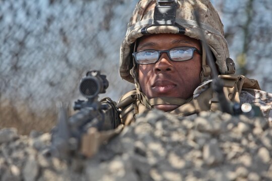 Corporal Howard Savage, combat engineer, Bridge Company, 7th Engineer Support Battalion, 1st Marine Logistics Group, provides security while others from his unit construct a forward operating base, a secured and fortified location used to increase operational tempo in forward deployed areas, during a field training exercise aboard Camp Pendleton, Calif., June 12, 2014. The FOB was approximately 40,000 sq. meters and consisted of four 20-foot tall guard posts, a command and control center, as well as several other structures used for facilitating the safe and effective environment for planning and conducting operations.


