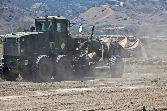 A grater levels terrain around a command and control center as approximately 100 Marines with Bravo Company, 7th Engineer Support Battalion, 1st Marine Logistics Group, construct a forward operating base, a secured and fortified location used to increase operational tempo in forward deployed areas, during a field training exercise aboard Camp Pendleton, Calif., June 12, 2014. The FOB was approximately 40,000 sq. meters and consisted of four 20-foot tall guard posts, a command and control center, as well as several other structures used for facilitating the safe and effective environment for planning and conducting operations.


