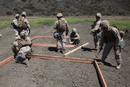 Marines with Bravo Company, 7th Engineer Support, 1st Marine Logistics Group, construct the foundation for guard towers while building a forward operating base, a secured and fortified location used to increase operational tempo in forward deployed areas, during a field training exercise aboard Camp Pendleton, Calif., June 11, 2014. The FOB was approximately 40,000 sq. meters and consisted of four 20-foot tall guard posts, a command and control center, as well as several other structures used for facilitating the safe and effective environment for planning and conducting operations.


