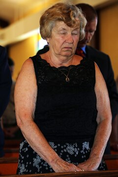 Elizabeth Smith joins a congregation of more than 100 Marines, Sailors and civilian friends and family in prayer during the rededication of the Caruso Chapel, at the School of Infantry-West, here, June 23.

The chapel was initially dedicated to Caruso in 1953 and he was awarded the Silver Star Medal in 1950 for shielding father Connie Griffin, a chaplain then assigned to the 7th Marine Division (reinforced), from enemy fire with his body during an ambush in the Korean War, Dec. 6, 1950.

“It’s terrific to be here this time since I missed the first one,” said Smith. Smith was unable to travel due to pregnancy during the chapel’s initial dedication. “The ceremony was stirring and it’s such an honor to be here. My husband made a tremendous sacrifice.”
