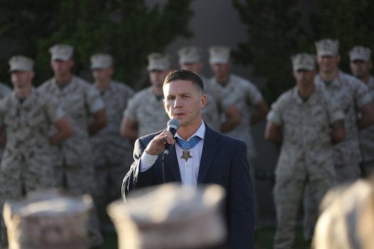 Cpl. William “Kyle” Carpenter, Medal of Honor recipient, speaks during an evening colors ceremony aboard Marine Corps Air Station Miramar Calif., June 23. Carpenter, the most recent Medal of Honor recipient, attended the ceremony as the guest of honor and spoke about the impact noncommissioned officers can make on junior Marines.