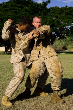 Petty Officer 3rd Class Damien Farinha, left, a hospital corpsman with Marine All-Weather Fighter Attack Squadron 242, performs the counter to a bear hug during an integrated Marine Corps Martial Arts Program course as part Exercise Southern Frontier 2014 aboard Royal Australian Air Force Base Tindal, Australia, June 18. Farinha is one of approximately 40 service members taking part in the course during SF14.    
