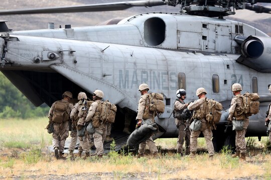 Marines with 1st Battalion, 1st Marine Regiment, board a CH-53E Super Stallion with Marine Heavy Helicopter Squadron (HMH) 465 during an insertion and extraction exercise aboard Marine Corps Base Camp Pendleton, Calif., June 27.  Marines were inserted into an objective area to perform simulated actions to gain control of an objective area. 