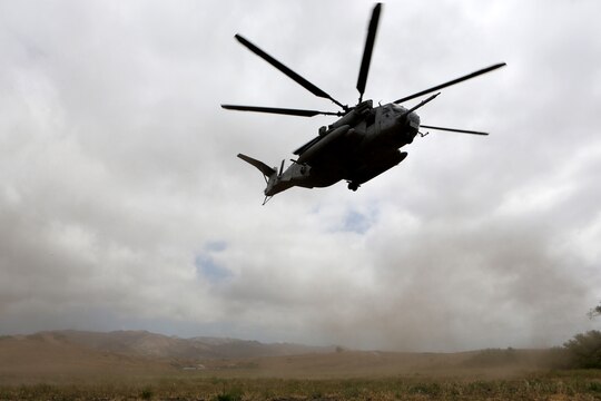 A CH-53E Super Stallion with Marine Heavy Helicopter Squadron (HMH) 465 takes off while carrying Marines to an objective area during training aboard Marine Corps Base Camp Pendleton, Calif., June 27. The training was held to exercise communication techniques between the pilots and ground units.