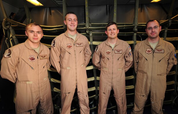 Capt. Tim Farwell, Capt. Sebastian Dauby, Senior Airman Christopher Wampler and Senior Airman Shawn Aldrich, 908th Expeditionary Air Refueling Squadron KC-10 Extender crew, pose for a photo after returning from a flight at an undisclosed location in Southwest Asia, March 7, 2014. (U.S. Air Force photo by Staff Sgt. Michael Means/Released)