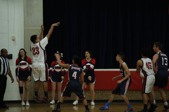 Quantico Middle/High School Senior Anthony shoots from beyond the arc in a home game against St. Michael the Archangel High School of Fredericksburg on Jan. 27, 2014. Anthony anchored the team by scoring 14, securing a 65-52 win.