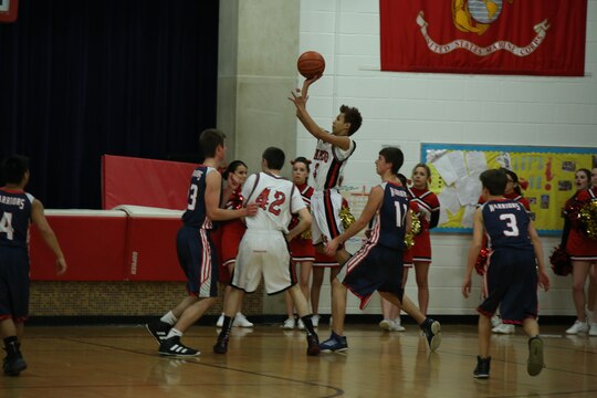 Naiko, a sophomore at the Quantico Middle/High School, takes a jump shot in a home game against St. Michael the Archangel High School of Fredericksburg on Jan. 27, 2104. Naiko scored nine points for Quantico in the 65-52 win.  