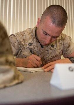 Gunnery Sgt. Jason Dicosima, utilities officer in charge with Engineering Company, Marine Wing Support Squadron 374, writes down his personal mission statement during Master Sergeant – Gunnery Sergeant Committed and Engaged Leadership Symposium aboard Marine Corps Air Station Miramar, Calif., March 19 – 21. Symposium leadership encouraged participants like Dicosima to look within themselves, re-evaluate and re-invest in their positions as leaders in the Marine Corps.