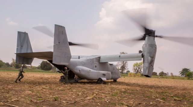 Royal Thai Air Force Flying Officer Satapat Rattana, runs into an MV-22B Osprey during a tactical recovery of aircraft and personnel drill Feb. 13 during Exercise Cobra Gold 2014. CG 14 is a joint, multinational exercise conducted annually in the Kingdom of Thailand aimed at enhancing and increasing combined interoperability. Rattana is a pilot with Squadron 403, Wing 4, Royal Thai Air Force. The MV-22B Osprey is with Marine Medium Tiltrotor Squadron 262, Marine Aircraft Group 36, 1st Marine Aircraft Wing, III Marine Expeditionary Force.