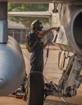 Lance Cpl. Tiffany Meyers pumps hydraulic fluid into an FA-18D Hornet aboard Wing One Royal Thai Air Force Base, Nakhon Ratchasima, Kingdom of Thailand, during a preflight check Feb. 20 during Exercise Cobra Gold 2014. CG 14 is a joint, multinational exercise conducted annually in the Kingdom of Thailand aimed at enhancing and increasing multinational interoperability. Meyers is an airframes mechanic with Marine All Weather Fighter Attack Squadron 242, Marine Aircraft Group 12, 1st Marine Aircraft Wing, III Marine Expeditionary Force. The FA-18D Hornet is with VMFA(AW)-242.