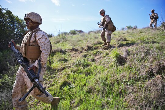 Corporal Tyrone Stackfield, motor transportation operator, Alpha Company, 7th Engineer Support Battalion, 1st Marine Logistics Group, and his fire team, conduct area and route reconnaissance during the company's super squad competition aboard Camp Pendleton, Calif., March 12, 2014. Eight squads, of approximately 80 Marines and sailors, from Alpha Company participated in the weeklong competition that focused on infantry rifle squad skills, tested small-unit leadership and their combat-readiness. Stackfield, 25, is from Los Angeles. (U.S. Marine Corps photo by Cpl. Timothy Childers / Released)
