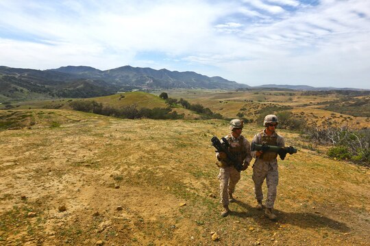Corporal Alex A. Salomone (left), bulk fuels specialist, Alpha Company, 7th Engineer Support Battalion, 1st Marine Logistics Group, and Cpl. Cody Collins, combat engineer, Alpha Company, approach a firing-line carrying a Shoulder-launched Multipurpose Assault Weapon and rocket during a live-fire range and competition aboard Camp Pendleton, Calif., March 11, 2014. Eight squads, of approximately 80 Marines and sailors, from Alpha Company participated in the weeklong competition that focused on infantry rifle squad skills, tested small-unit leadership and their combat-readiness. Collins, 21, is from Vandalia, Ohio.