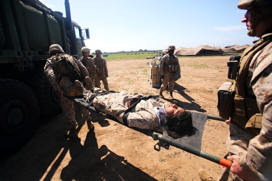 Seamans Damian Aguilar (left) and Stephen Ruhe (right) carry Lance Cpl. Elizabeth DeLaRosa, an administrative clerk, Headquarters Company, Combat Logistics Regiment 1, 1st Marine Logistics Group, on a stretcher after providing on-the-spot medical care as part of a medical-response exercise during Command Post Exercise 1, aboard Camp Pendleton, Calif., March 12, 2014. CPX1 and the upcoming CPX2 provide 1st MLG a clear picture of command and control standard operating procedures they need to refine and the day-to-day requirements they will need to fulfill during Operation Desert Scimitar 2014 in May.