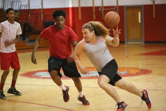 Stephen DiCenso, a student at Lejeune High School, drives the ball to the hoop for the Lejeune Lakers during the Lejeune March Madness basketball tournament at Lejeune High School, March 21. The Lejeune Lakers were defeated by the Lejeune Clippers 61-50.