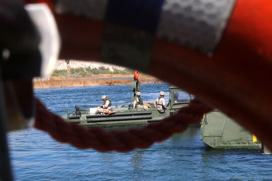 Marines with Bridge Company, 7th Engineer Support Battalion, 1st Marine Logistics Group, drive a Combat Rubber Raiding Craft onto the back of an Improved Ribbon Bridge during a training exercise on the Colorado River in Laughlin, Nev., March 17-21, 2014. More than 60 Marines trained in moving heavy equipment, to include 7-tons and Humvees, across a flowing body of water using BEBs and an Improved Ribbon Bridge. The IRB is a multi-piece floating bridge that can function as a raft. The BEBs were used to push the raft against the current. Despite being accustomed to training in a bay with little to no current, these Marines managed to transport two 7-tons up the river at the same time.