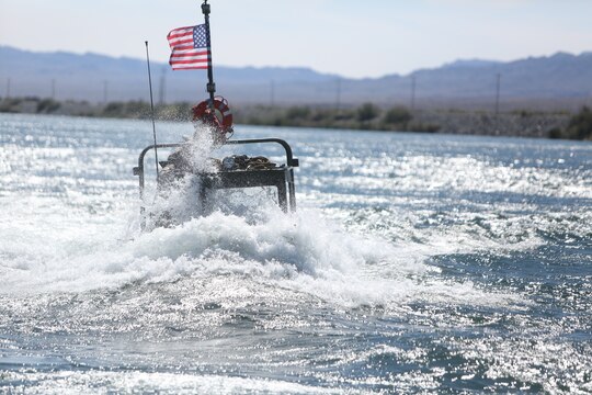 A Bridge Erection Boat faces the current of the Colorado River during a training exercise executed by Marines with Bridge Company, 7th Engineer Support Battalion, 1st Marine Logistics Group, in Laughlin, Nev., March 17-21, 2014. More than 60 Marines trained in moving heavy equipment, to include 7-tons and Humvees, across a flowing body of water using BEBs and an Improved Ribbon Bridge. The IRB is a multi-piece floating bridge that can function as a raft. The BEBs were used to push the raft against the current. Despite being accustomed to training in a bay with little to no current, these Marines managed to transport two 7-tons up the river at the same time.