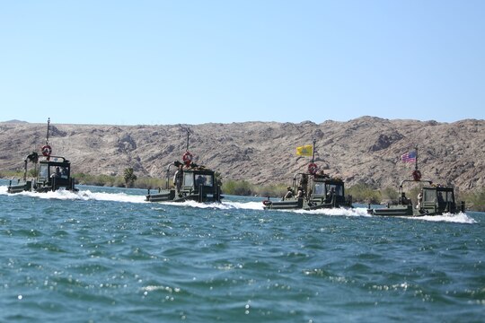 Marines with Bridge Company, 7th Engineer Support Battalion, 1st Marine Logistics Group, operate Bridge Erection Boats as part of a rafting exercise on the Colorado River in Laughlin, Nev., March 17-21, 2014. More than 60 Marines trained in moving heavy equipment, to include 7-tons and Humvees, across a flowing body of water utilizing BEBs and an Improved Ribbon Bridge. The IRB is a multi-piece floating bridge that can function as a raft. The BEBs were used to push the raft against the current. Despite being accustomed to training in a bay with little to no current, these Marines managed to transport two 7-tons up the river at the same time.