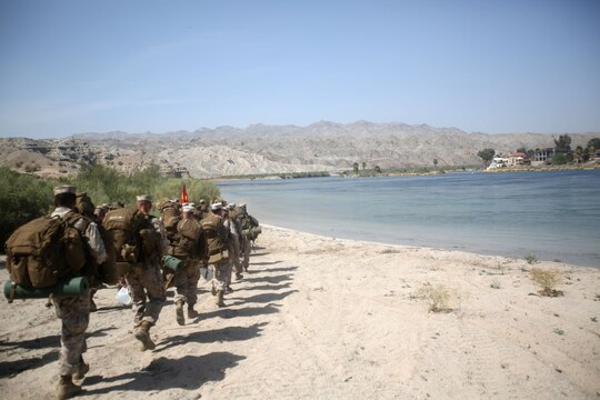 Marines with Bridge Company, 7th Engineer Support Battalion, 1st Marine Logistics Group, march to their training site for a rafting exercise on the Colorado River in Laughlin, Nev., March 17-21, 2014. More than 60 Marines trained in moving heavy equipment, to include 7-tons and Humvees, across a flowing body of water using Bridge Erection Boats and an Improved Ribbon Bridge. The IRB is a multi-piece floating bridge that can function as a raft. Despite being accustomed to training in a bay with little to no current, these Marines managed to transport two 7-tons up the river at the same time.