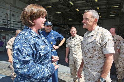 Brigadier Gen. Vincent A. Coglianese, commanding general, 1st Marine Logistics Group, speaks to Lieutenant Cmdr. Jennifer L. Forbes, executive officer of amphibious transport dock ship USS Anchorage (LPD 23), March 20, 2014. Anchorage, with embarked Marines from 1st Marine Expeditionary Force, was off the coast of California conducting amphibious warfare certification training. The Marines will conduct aircraft landing operations, live-fire training, martial arts and other drills in order to maintain their position as an expeditionary force in readiness.