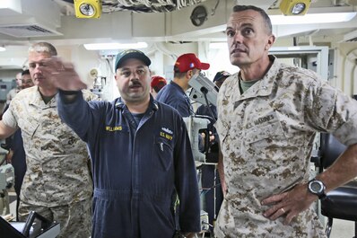 Brigadier Gen. Vincent A. Coglianese, right, commanding general, 1st Marine Logistics Group, speaks to Senior Chief Electrician’s Mate Glenn Williams, aboard amphibious transport dock ship USS Anchorage (LPD 23), regarding the ship’s navigation systems, March 20, 2014. The USS Anchorage, with embarked Marines from 1st Marine Expeditionary Force, was off the coast of California conducting amphibious warfare certification training. The embarked Marines will conduct aircraft landing operations, live-fire training, martial arts and other drills in order to maintain their position as an expeditionary force in readiness.
