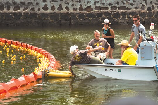 Race officials retrieve the first place rubber duckie from the Ala Wai Canal in Honolulu, during the United Cerebral Palsy Association of Hawaii’s 27th Annual Great Hawaiian Rubber Duckie Race, March 21, 2014. While the majority of 3rd Battalion, 3rd Marine Regiment Marines train at the Mountain Warfare Training Center, in Bridgeport, Calif., Marines in the remain-behind element filled Ala Wai Canal with rubber duckies to support the annual event, which raises money to help people who have cerebral palsy. (U.S. Marine Corps photo by Lance Cpl. Matthew Bragg)