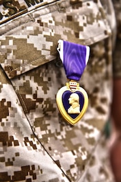 Lance Cpl. Gabriel R. Gehr, electrical equipment system technician with Utilities Platoon, Engineer Maintenance Company, 1st Maintenance Battalion, 1st Marine Logistics Group, wears the Purple Heart after receiving the medal aboard Camp Pendleton, Calif., May 5, 2014. More than a year earlier on Nov. 20, 2013, Gehr sustained shrapnel injuries from an anti-tank rocket while supporting Operation Enduring Freedom.