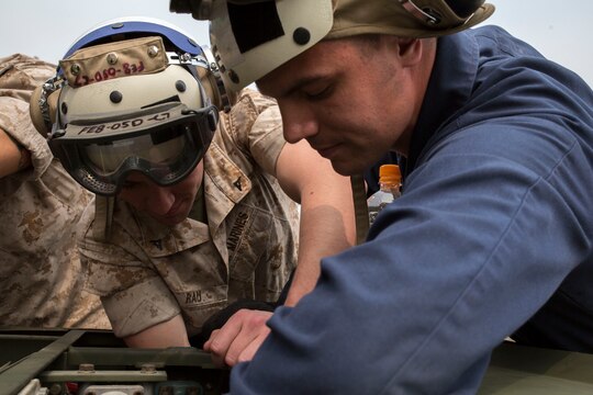 Lance Cpl. Kevin Rau, left, a ground support equipment mechanic with Marine Fighter Attack Squadron 122, and Lance Cpl. Joshua Keecer, a GSE mechanic with Marine Aviation Logistics Squadron 12, inspect a self-driven weapons loader during Exercise Max Thunder 14-1 aboard Gwangju Air Base, Republic of Korea April 20, 2014. During MT 14-1, Marines utilized weapons loaders to transport ordnance from various locations aboard Gwanju.        