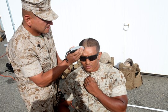 Sergeant Luis Manzo, platoon guide, 2nd Platoon, General Support Motor Transport Company, Combat Logistics Regiment 1, 1st Marine Logistics Group, shaves the head of Lance Cpl. Salauddin Miah, motor transport operator, 2nd Plt., GSMT Co., CLR-1, 1st MLG, aboard Camp Pendleton, Calif., May 5, 2014. Nineteen Marines with 2nd Plt., GSMT Co., CLR-1, 1st MLG shaved their heads to support their platoon sergeant’s 16-year old cousin, Diego Romero, who was recently diagnosed leukemia.