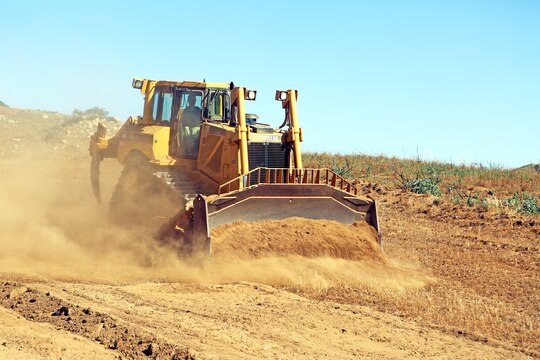 Lance Cpl. Matthew Brown, engineer equipment operator, Support Company, 7th Engineer Support Battalion, 1st Marine Logistics Group, plows brush along a firebreak path using a V8T Dozer aboard Camp Pendleton, Calif., May 13, 2014. Facilities Maintenance Division and seven Marines with 7th ESB, 1st MLG, began creating firebreaks May 6, 2014 in an effort to contain wildfires that may start on base and will continue to create them through Aug. 10, 2014. The FMD employees and 7th ESB Marines are still slated to meet this completion date even with the fire that destroyed 6,000 acres and caused hundreds of service members and their families to evacuate their on-base homes, May 14, 2014.