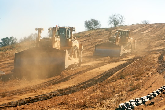 Two V8T Dozers cut brush along a path, creating a firebreak aboard Camp Pendleton, Calif., May 13, 2014. Facilities Maintenance Division and seven Marines with 7th Engineer Support Battalion, 1st Marine Logistics Group, began creating firebreaks May 6, 2014 in an effort to contain wildfires that may start on base and will continue to create them through Aug. 10, 2014. The FMD employees and 7th ESB Marines are still slated to meet this completion date even with the fire that destroyed 6,000 acres and caused hundreds of service members and their families to evacuate their on-base homes, May 14, 2014.