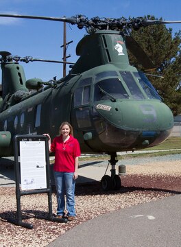 Morgan Tingle, Flying Leatherneck Aviation Museum docent, poses by her favorite aircraft display, a CH-46 Sea Knight, flown during Operation Frequent Wind, aboard Marine Corps Air Station Miramar, Calif., May 9. Tingle volunteers with the museum, giving tours, coordinating group visits and field trips, as well as researching and writing grants.