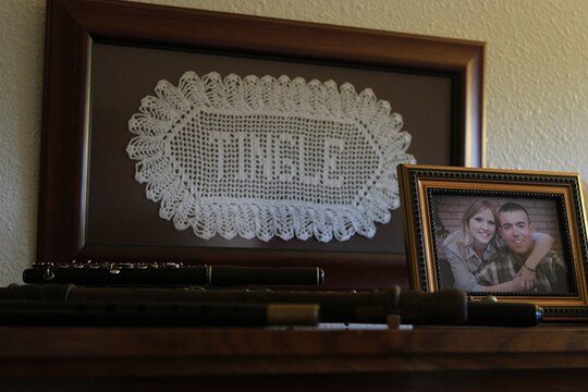 MARINE CORPS AIR STATION MIRAMAR, Calif. – An old piano, laden with antique flutes and fifes, a framed applique of the family surname, and a photo of Cpl. Jesse Tingle and his wife, Morgan Tingle, resides in their home, aboard Marine Corps Air Station Miramar, Calif., May 11. Cpl. Jesse Tingle and his wife, Morgan Tingle, share a love of history through their hobbies and occupations. 