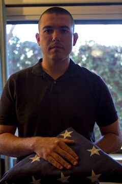 Cpl. Jesse Tingle, a musician with the 3rd Marine Aircraft Wing Band, holds a folded American flag in his home, aboard Marine Corps Air Station Miramar, Calif., May 11. The flag was flown at the dedication of the Miramar National Cemetery in January 2010. Tingle collects historical American flags. He owns several historical flags with various numbers of stars. Some of his prized flags include the flag shown, given to him by retired Sgt. Maj. Michael Zacker, a 48-star burial flag, given by a member of his church, and a 45-star flag he purchased last year. He received his favorite flag at an early age, a 48-star flag, given to him by his father.
