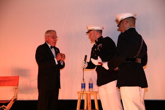 Capt. Jim Stenger, middle, public affairs officer, and 1st Lt. Leroy Um, right, adjutant, surprise retired Marine Maj. Donald “Donnie” R. Dunagan on stage at The Pickwick Theater in Park Ridge, Ill., Oct. 30, during the 75th anniversary screening of the movie “Son of Frankenstein.” Dunagan received a letter of appreciation from the Marines of 9th Marine Corps Recruiting District, Brig. Gen. James Bierman, commanding general of Marine Corps Recruit Depot San Diego and the Western Recruiting Region, and Col. Jason Morris, commanding officer of 9th District, for his many years of service in the Marine Corps, while also being honored that night for his continuing contribution to the film industry.