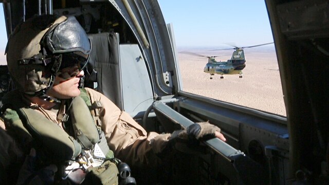 Staff Sgt. Derek Burleson, a crew chief with Marine Medium Tiltrotor Squadron (VMM) 364, looks out the window during the last CH-46E flight on the way to Davis-Monthan Air Force Base, Ariz., Oct. 29. The squadron will transfer to the MV-22B Osprey after the aircraft is inducted into the 309th Aerospace Maintenance and Regeneration Group.
