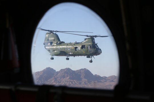 A CH-46E Sea Knight with Marine Medium Tiltrotor Squadron (VMM) 364 flies its last flight to Davis-Monthan Air Force Base, Ariz., Oct. 29. The aircraft was inducted into the 309th Aerospace Maintenance And Regeneration Group, an aircraft gravesite appropriately known as the boneyard. The aircraft was painted an olive green to resemble its original colors during the Vietnam War.