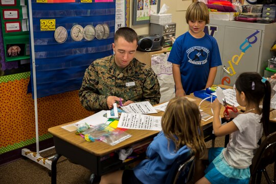 Lance Cpl. Schuyler Frincke, a safety and survival specialist with Marine Medium Tiltrotor Squadron (VMM) 268, helps a group of students with their classwork at Morning Creek Elementary School, Nov. 5. Marines come out every Wednesday to volunteer at this school for the children.