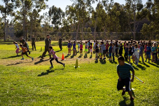 Marine volunteers supervise students from Morning Creek Elementary School during a hurdling event, Nov. 5. Marines visit the school to help mentor students in Mrs. Amy P. Budde’s 2nd grade class every Wednesday.