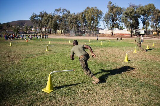 Two Marines show students how to do a workout challenge at Morning Creek Elementary School, Nov. 5. Marines visited the school to volunteer with students at Mrs. Amy P. Budde’s 2nd grade class.