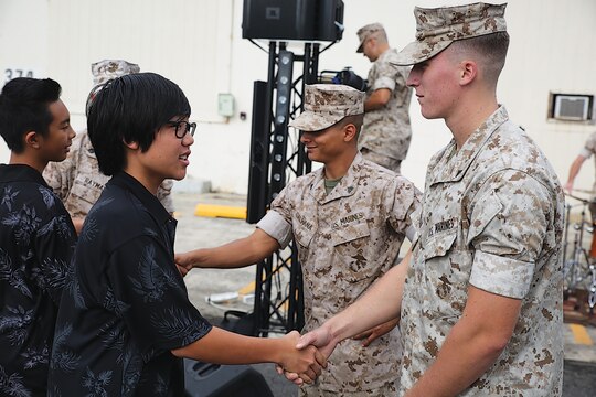 MARINE CORPS BASE HAWAII - After the performances, students from Iolani met with Marines who were able to help them practice concert music. Each of the students were assisted by a Marine who either played the same instrument or was in the same section. U.S. Marine Corps Forces, Pacific, Band hosted students from Iolani School Oct. 30 at the band hall. The event was proposed to promote public relations and music education in the community. (U.S. Marine Corps photo by Pfc. Harley Thomas)