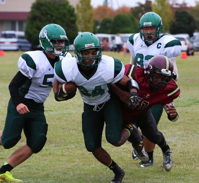 Jarvis Stokes, Daegu Warriors receiver, runs from Jarell Davis, a Matthew C. Perry Samurai linebacker, during the 2014 Department of Defense Dependents Schools Far East Division II Football Championship Game at the Matthew C. Perry High School football field aboard Marine Corps Air Station Iwakuni, Japan, Nov. 8, 2014. The Warriors defeated the Samurai 60-50 to claim their fourth Division II football title. 
