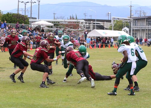 Jarell Davis, a Matthew C. Perry linebacker, stops Josh McCaw, a Daegu Warriors running back, near the goal line during the 2014 Department of Defense Dependents Schools Far East Division II Football Championship Game at the Matthew C. Perry High School football field aboard Marine Corps Air Station Iwakuni, Japan, Nov. 8, 2014. The Warriors defeated the Samurai 60-50, claiming their fourth Division II title. 