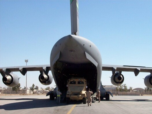 Aerial Port personnel down-load a MRAP vehicle from a C-17 Globemaster III. 8th Expeditionary Air Mobility Squadron personnel provide critical “hub and spoke” capability for air cargo movement and strategic airlift, C-17 and C-5, maintenance to provide Air Mobility Command and CENTCOM the ability to deliver mission requirements.(Courtesy Photo)