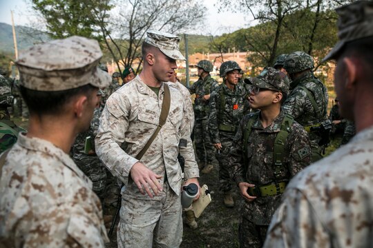 U.S. Marine Capt. Joseph Mozzi, from Dalton, Massachusetts, discusses a battle plan with his Republic of Korea Marine counterpart Oct. 7 at Rodriguez Live Fire Complex during Korean Marine Exchange Program 14-13. From planning to execution, KMEP 14-13 was a bilateral and collaborative effort between ROK and U.S. Marine Corps forces. The ROK Marines are with 2nd Battalion, 8th Brigade, 2nd ROK Marine Division. Mozzi is the supporting arms liaison alpha team leader with 5th Air Naval Gunfire Liaison Company, III Marine Expeditionary Force Headquarters Group, III MEF. 