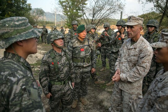 U.S. Marine Lt. Col. Christopher L. Medlin, right, speaks with unit leaders from the Republic of Korea Marine Corps Oct. 7 at Rodriguez Live Fire Complex during Korean Marine Exchange Program 14-13. KMEP is carried out in the spirit of the Republic of Korea-U.S. Mutual Defense Treaty signed between the two nations October 1, 1953. The exercise underlines the enduring alliance and friendship between the ROK and U.S. and highlights the two countries’ combined commitment to the defense of the ROK and peace and security in the region. The ROK Marines are with 2nd Battalion, 8th Brigade, 2nd ROK Marine Division. Medlin is the commanding officer of 1st Battalion, 3rd Marine Regiment, currently assigned to 4th Marine Regiment, 3rd Marine Division, III Marine Expeditionary Force, under the unit deployment program. 